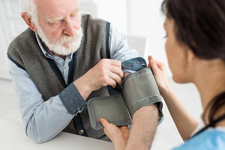 Nurse measuring blood pressure in assisted living